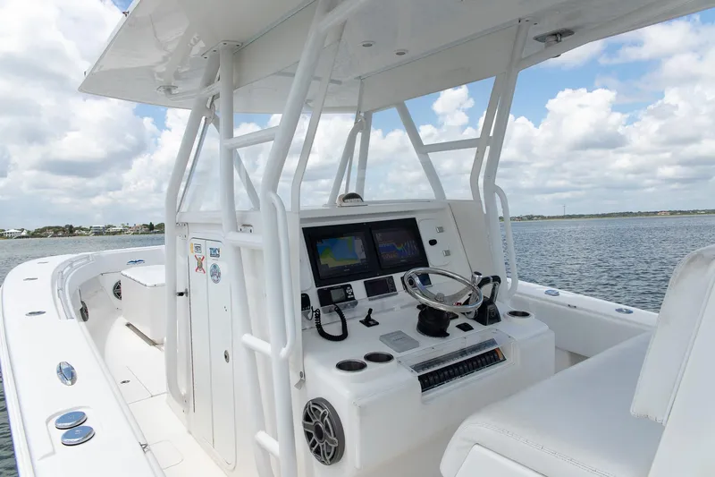  Yacht Photos Pics 2015 Invincible 36 Open Fisherman boat interior with navigation controls on a sunny day.