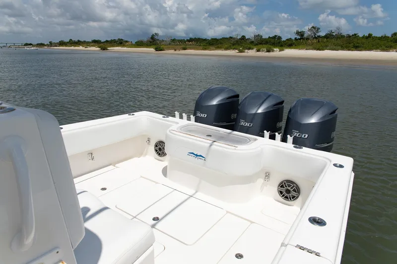  Yacht Photos Pics 2015 Invincible 36 Open Fisherman boat with triple Yamaha engines on calm water.