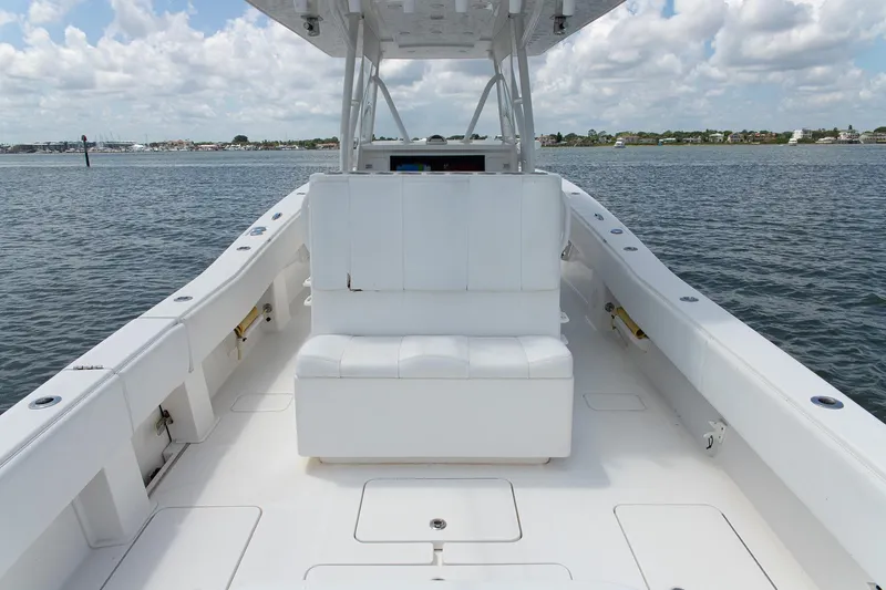  Yacht Photos Pics 2015 Invincible 36 Open Fisherman boat on calm water, featuring spacious seating and clear skies.