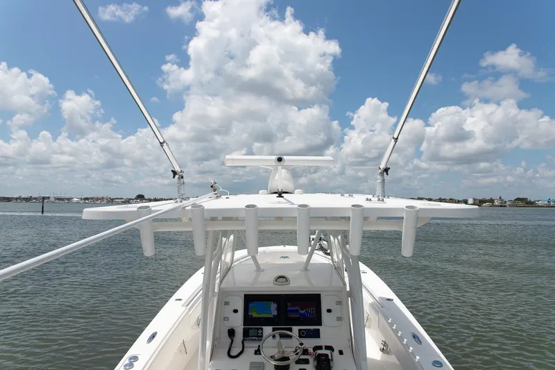  Yacht Photos Pics 2015 Invincible 36 Open Fisherman boat on calm water under a cloudy sky.