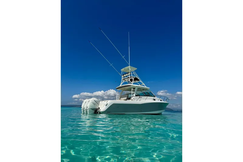  Yacht Photos Pics 2018 Boston Whaler 345 Conquest boat on clear turquoise water under blue sky.
