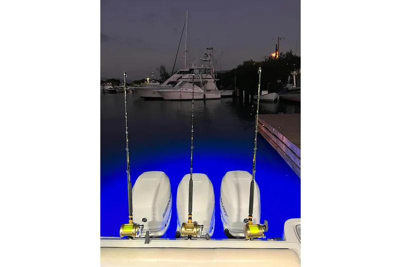  Yacht Photos Pics Boston Whaler 345 Conquest 2018 with fishing rods and illuminated water at night.