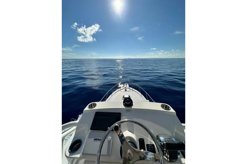  Yacht Photos Pics 2018 Boston Whaler 345 Conquest navigating open sea under clear blue sky.
