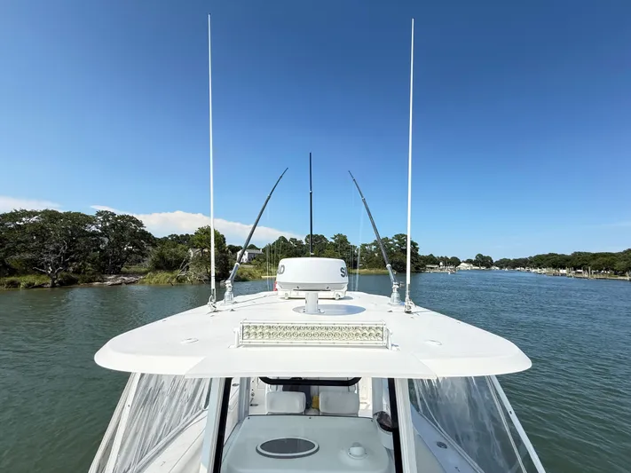  Yacht Photos Pics 2018 Sea Hunt Gamefish 30 boat navigating a scenic waterway with clear blue skies.