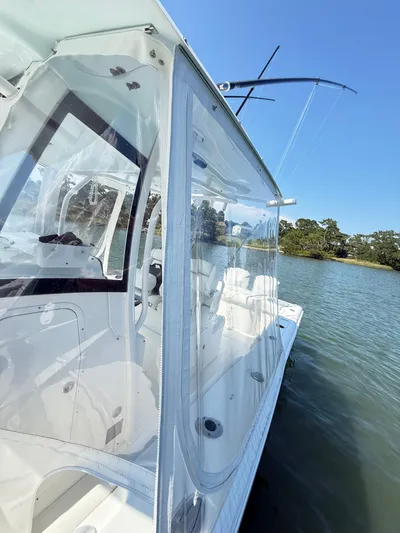  Yacht Photos Pics 2018 Sea Hunt Gamefish 30 boat with clear enclosure on calm water.