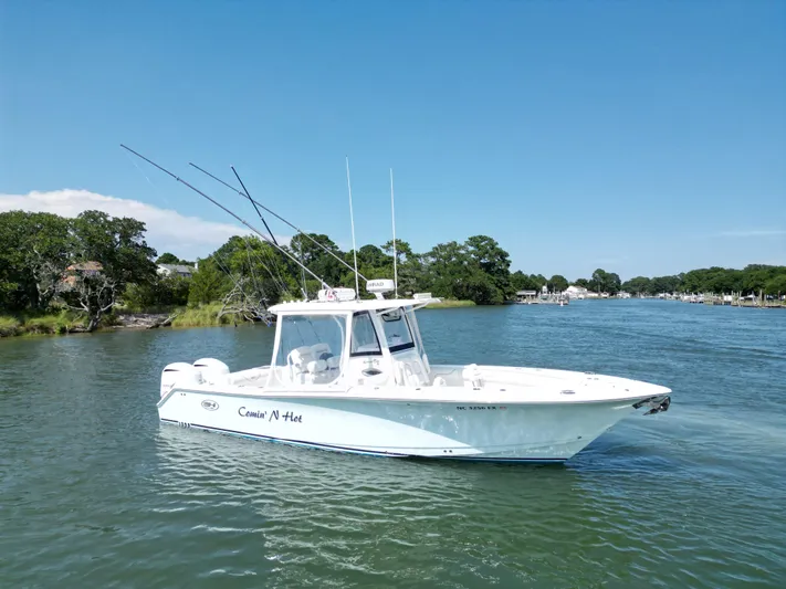  Yacht Photos Pics 2018 Sea Hunt Gamefish 30 boat on a scenic river with lush greenery.