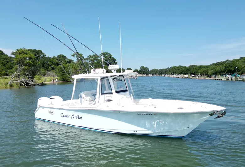  Yacht Photos Pics 2018 Sea Hunt Gamefish 30 boat on a scenic river with fishing rods.