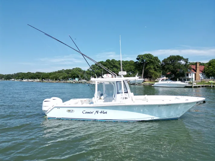  Yacht Photos Pics 2018 Sea Hunt Gamefish 30 boat on water, clear sky, coastal background.
