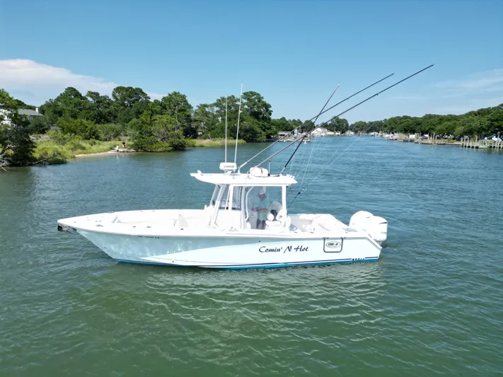  Yacht Photos Pics 2018 Sea Hunt Gamefish 30 boat on a serene river with lush greenery.