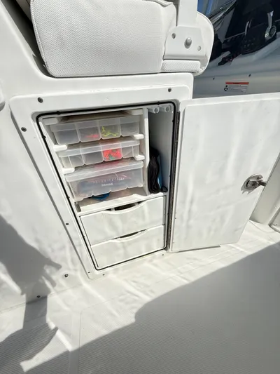  Yacht Photos Pics Storage compartment on 2018 Sea Hunt Gamefish 30, featuring organized tackle boxes and drawers.