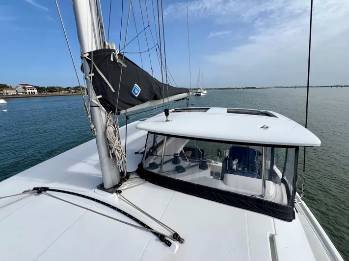 Roxie Yacht Photos Pics 2024 Lagoon 42 catamaran on calm water, showcasing sleek design and modern features.