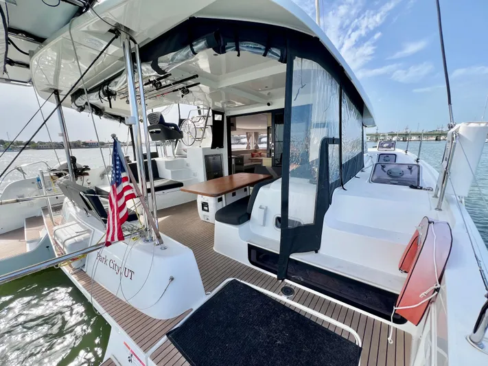 Roxie Yacht Photos Pics 2024 Lagoon 42 catamaran with spacious deck, modern design, and American flag.