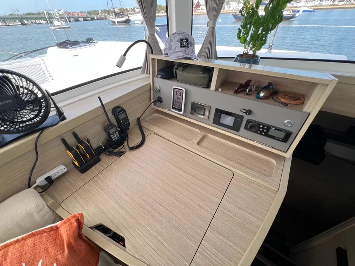 Roxie Yacht Photos Pics 2024 Lagoon 42 yacht interior with navigation station, gadgets, and sea view.
