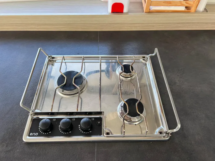 Roxie Yacht Photos Pics Three-burner stainless steel stove on Lagoon 42, 2024 model yacht kitchen.