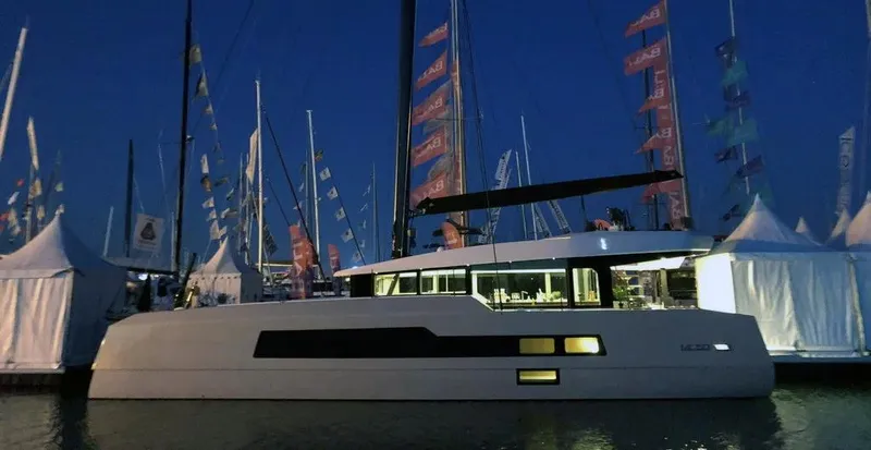  Yacht Photos Pics Luxury McConaghy MC55 yacht at night, docked with illuminated interior, 2026 model.