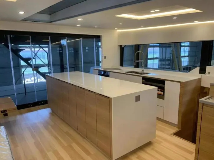  Yacht Photos Pics Modern kitchen interior on 2026 McConaghy MC55 yacht, featuring sleek design and wooden flooring.