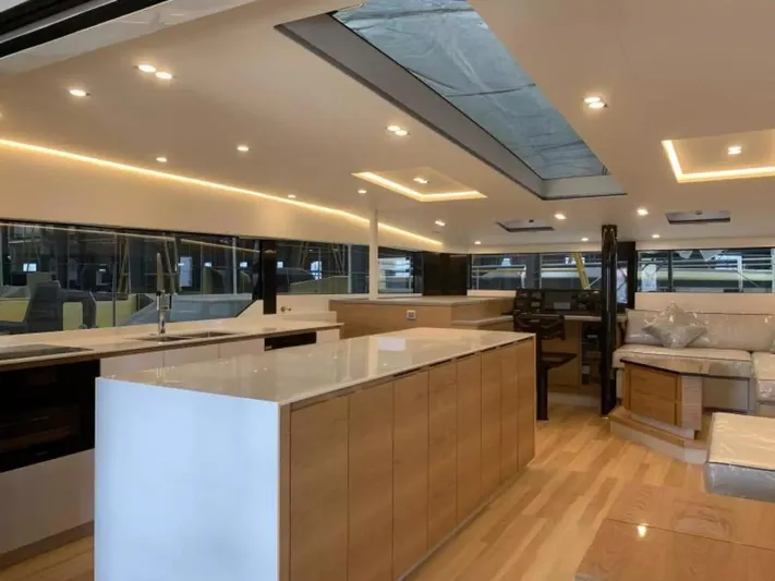  Yacht Photos Pics Luxurious interior of 2026 McConaghy MC55 yacht with modern kitchen and seating area.