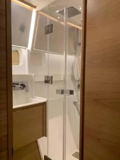  Yacht Photos Pics 2026 McConaghy MC55 yacht bathroom with modern shower and wooden cabinetry.
