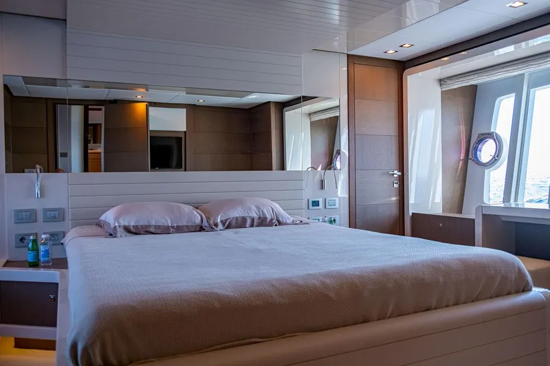  Yacht Photos Pics Luxurious bedroom interior of 2013 Ferretti Yachts 870 with modern design and large windows.