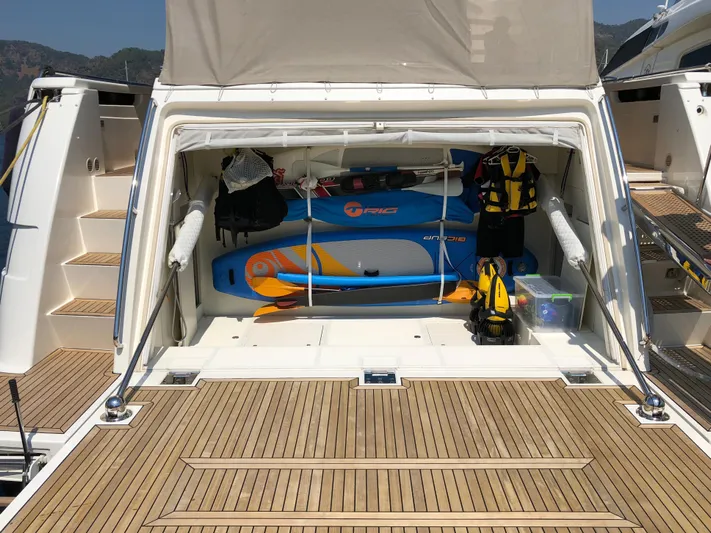  Yacht Photos Pics Ferretti Yachts 870 (2013) with open storage, paddleboard, and life jackets on teak deck.