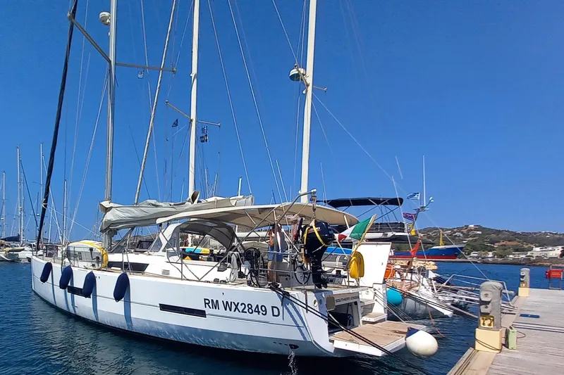 Southern Cross Yacht Photos Pics Sailing yacht Dufour 560 Grand Large 2015 docked at a marina under clear blue skies.
