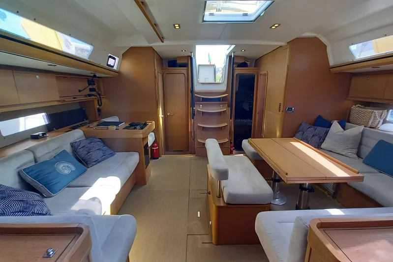 Southern Cross Yacht Photos Pics Luxurious interior of 2015 Dufour 560 Grand Large yacht with elegant seating and dining area.