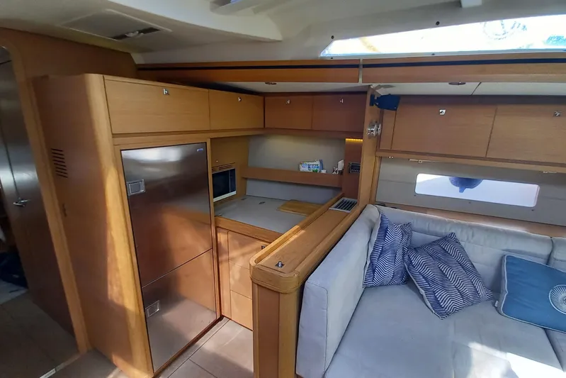 Southern Cross Yacht Photos Pics Interior of 2015 Dufour 560 Grand Large yacht with modern kitchen and cozy seating area.