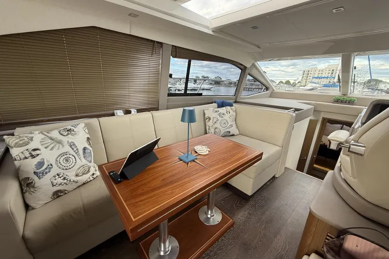  Yacht Photos Pics Luxurious interior of 2018 Sea Ray Sundancer 460 yacht with elegant seating and wooden table.