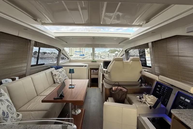  Yacht Photos Pics Luxurious interior of a 2018 Sea Ray Sundancer 460 yacht with modern seating and controls.