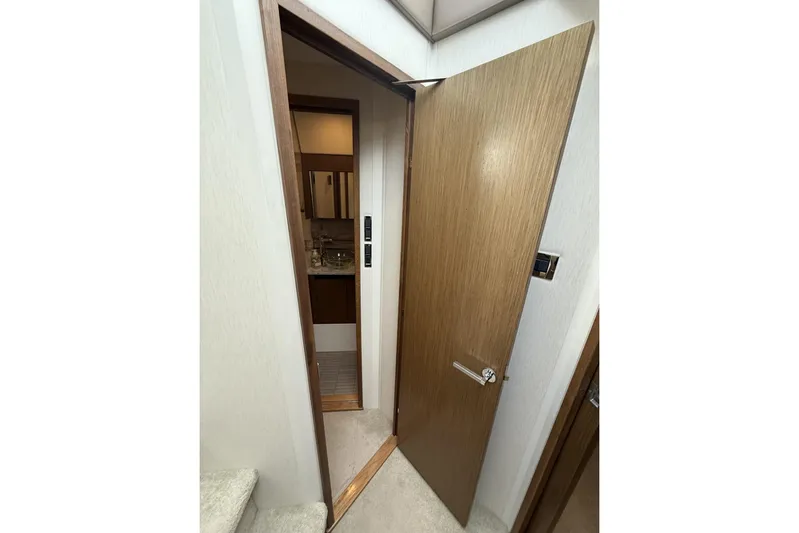 Yacht Photos Pics Interior view of 2018 Sea Ray Sundancer 460 yacht, featuring a wooden door and modern bathroom.