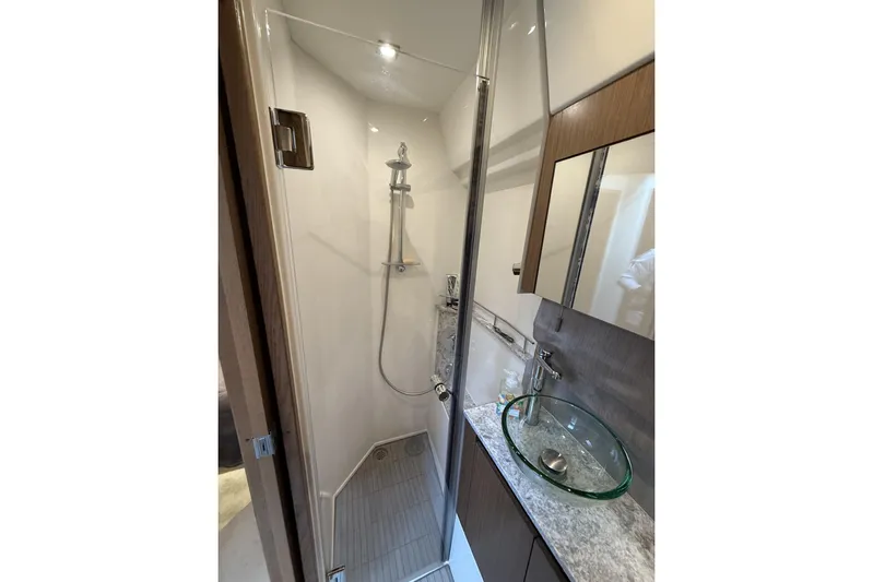  Yacht Photos Pics Luxurious bathroom in 2018 Sea Ray Sundancer 460 yacht with glass sink and modern shower.