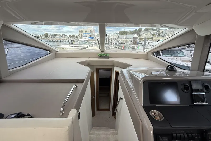  Yacht Photos Pics Interior view of 2018 Sea Ray Sundancer 460 yacht, featuring helm and cabin entrance.
