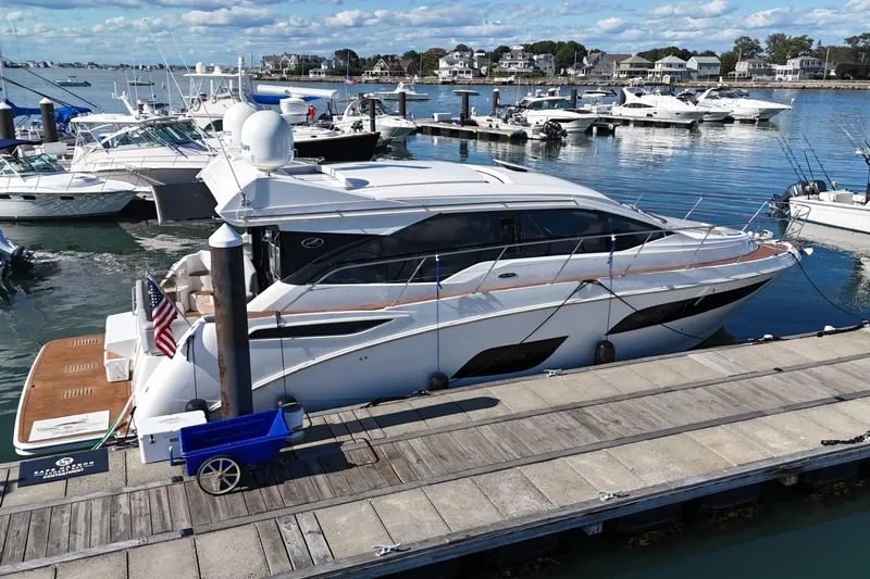  Yacht Photos Pics 2018 Sea Ray Sundancer 460 yacht docked at a marina with other boats.