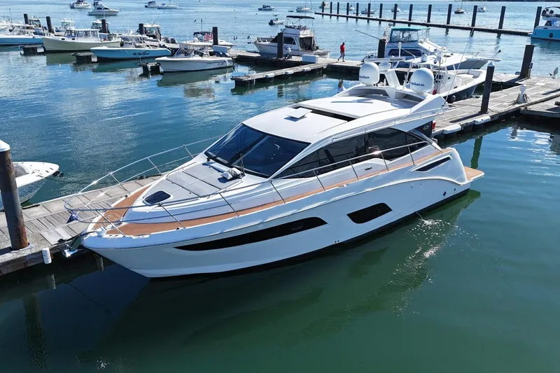  Yacht Photos Pics 2018 Sea Ray Sundancer 460 yacht docked at marina, surrounded by other boats.