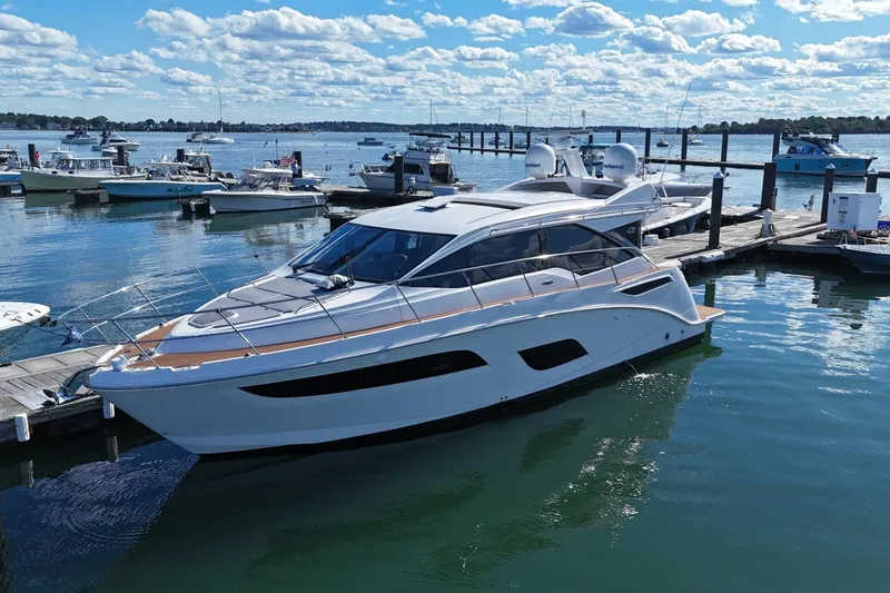  Yacht Photos Pics 2018 Sea Ray Sundancer 460 yacht docked at marina under blue sky.