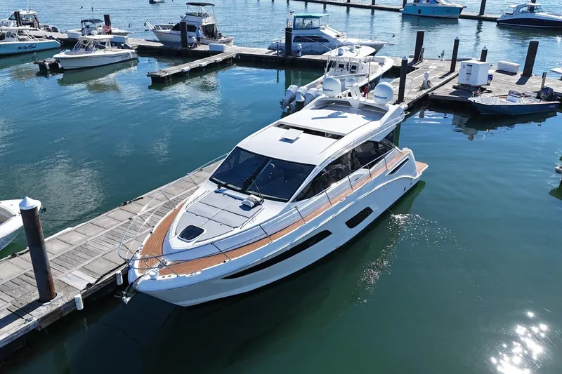  Yacht Photos Pics 2018 Sea Ray Sundancer 460 yacht docked at a marina, surrounded by other boats.