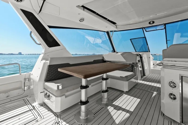  Yacht Photos Pics Interior of 2020 Aquila 36 yacht with seating and table, overlooking the ocean.