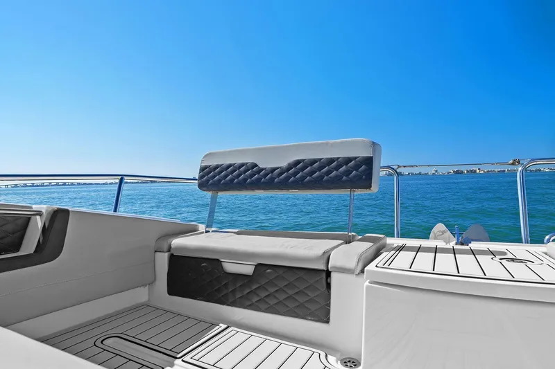  Yacht Photos Pics Aquila 36 boat interior with cushioned seating, ocean view, and clear blue sky.