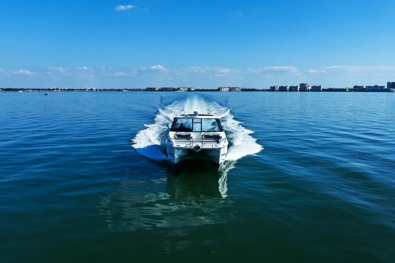  Yacht Photos Pics Aquila 36 boat cruising on calm blue waters under a clear sky, 2020 model.