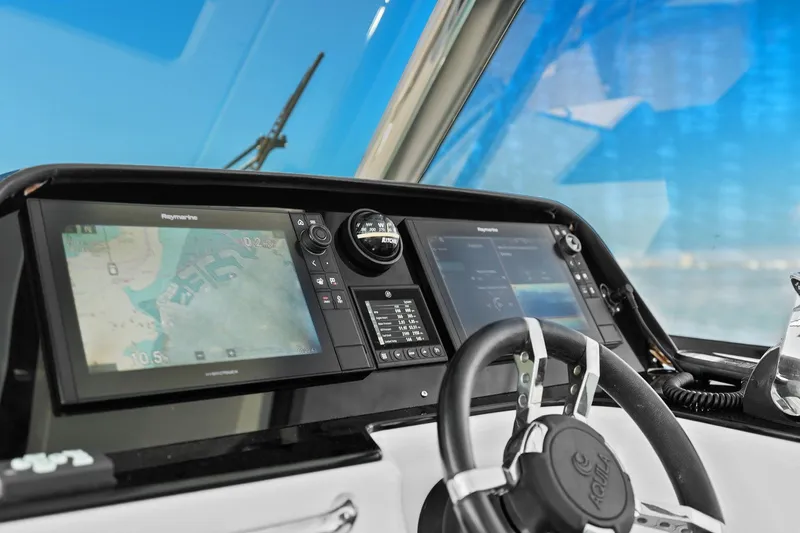  Yacht Photos Pics Aquila 36 yacht helm with navigation screens and steering wheel, 2020 model.