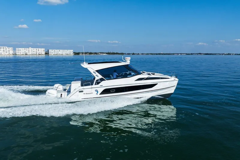  Yacht Photos Pics 2020 Aquila 36 yacht cruising on calm blue waters under a clear sky.