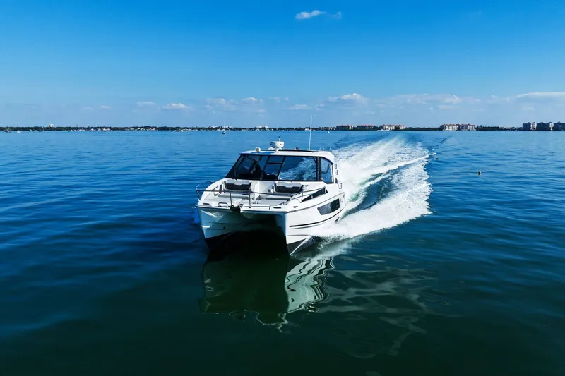  Yacht Photos Pics Aquila 36 boat cruising on calm blue waters under a clear sky, 2020 model.