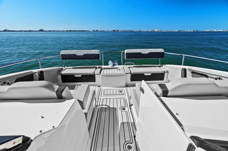  Yacht Photos Pics Aquila 36 boat interior with seating, overlooking calm blue waters, 2020 model.