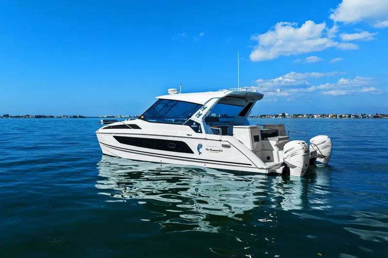  Yacht Photos Pics Aquila 36 boat, 2020 model, cruising on calm blue waters under a clear sky.