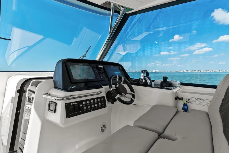  Yacht Photos Pics Interior view of 2020 Aquila 36 boat cockpit with navigation controls and ocean view.