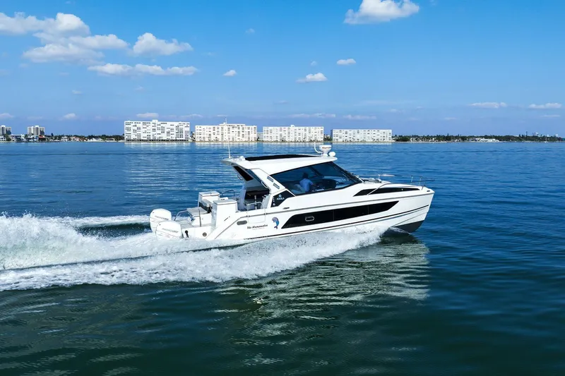  Yacht Photos Pics Aquila 36 boat cruising on calm waters under a clear blue sky, 2020 model.