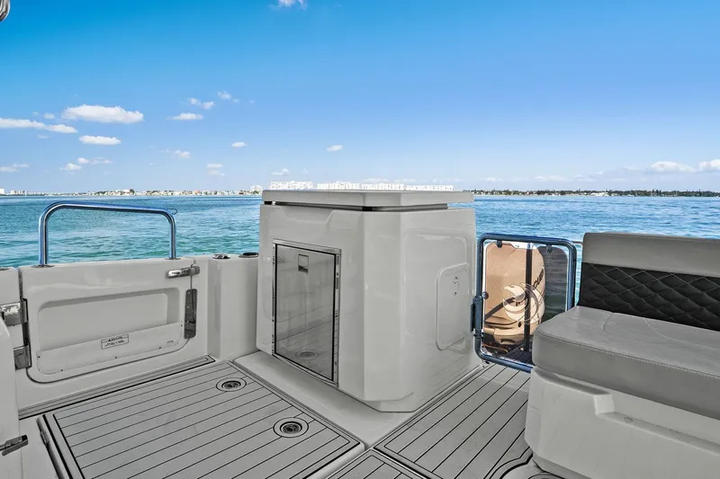  Yacht Photos Pics Aquila 36 boat interior with seating, ocean view, and clear blue sky.