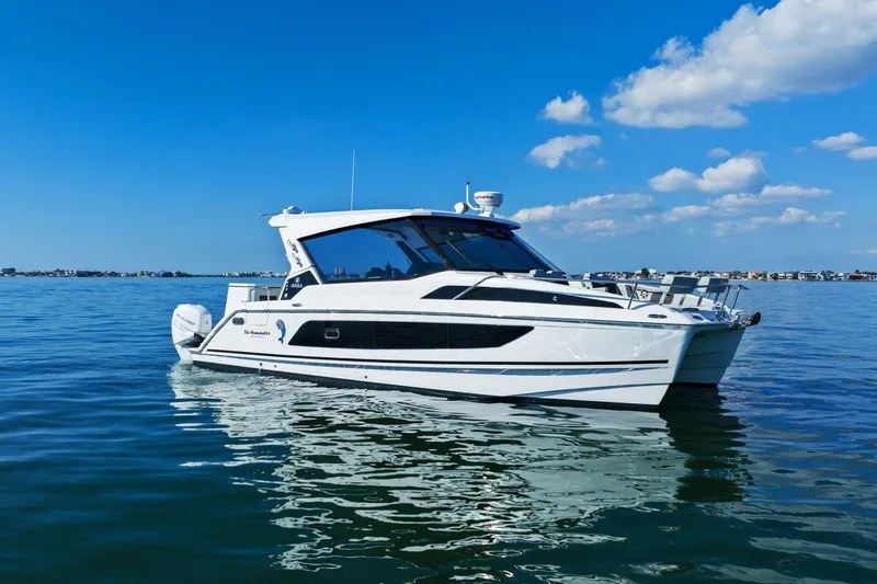  Yacht Photos Pics Aquila 36 boat from 2020 on calm water under a clear blue sky.