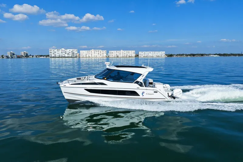  Yacht Photos Pics 2020 Aquila 36 boat cruising on calm water with cityscape background.