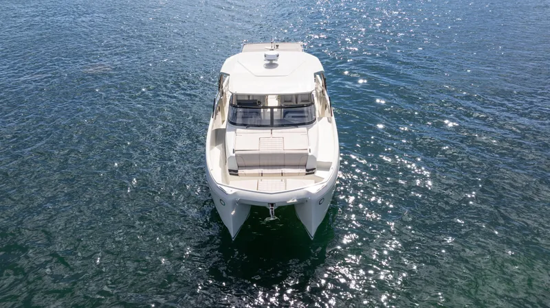  Yacht Photos Pics Aerial view of 2025 YOT 36 boat on sparkling blue water.